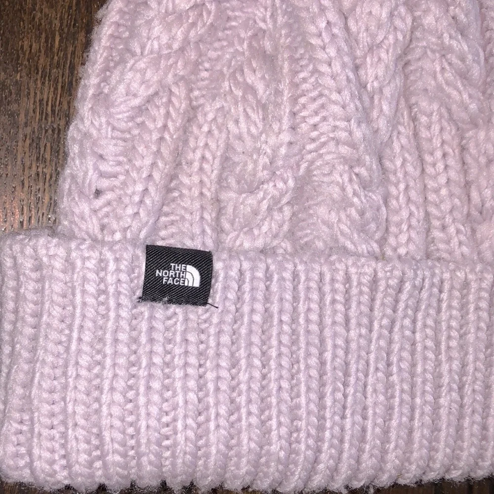 The north face lavender color beanie hat with large fluff Pom Pom